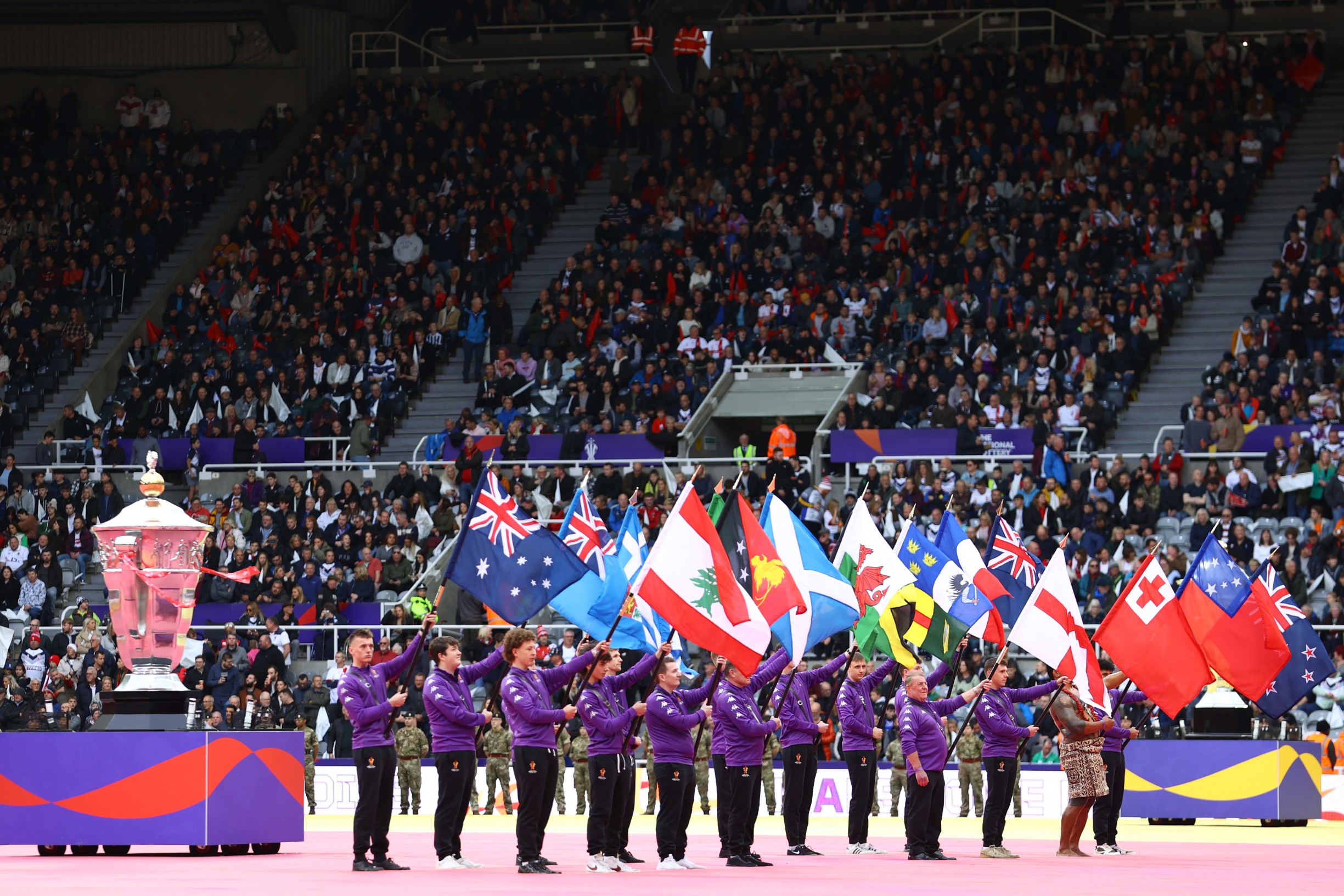 Flag holders on the pitch at St James' Park for the Rugby League World Cup