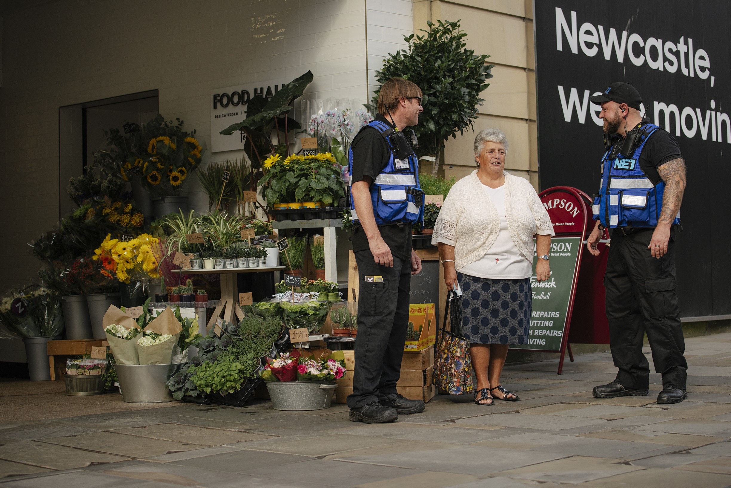 Two NE1 Street Rangers speaking to a member of the public