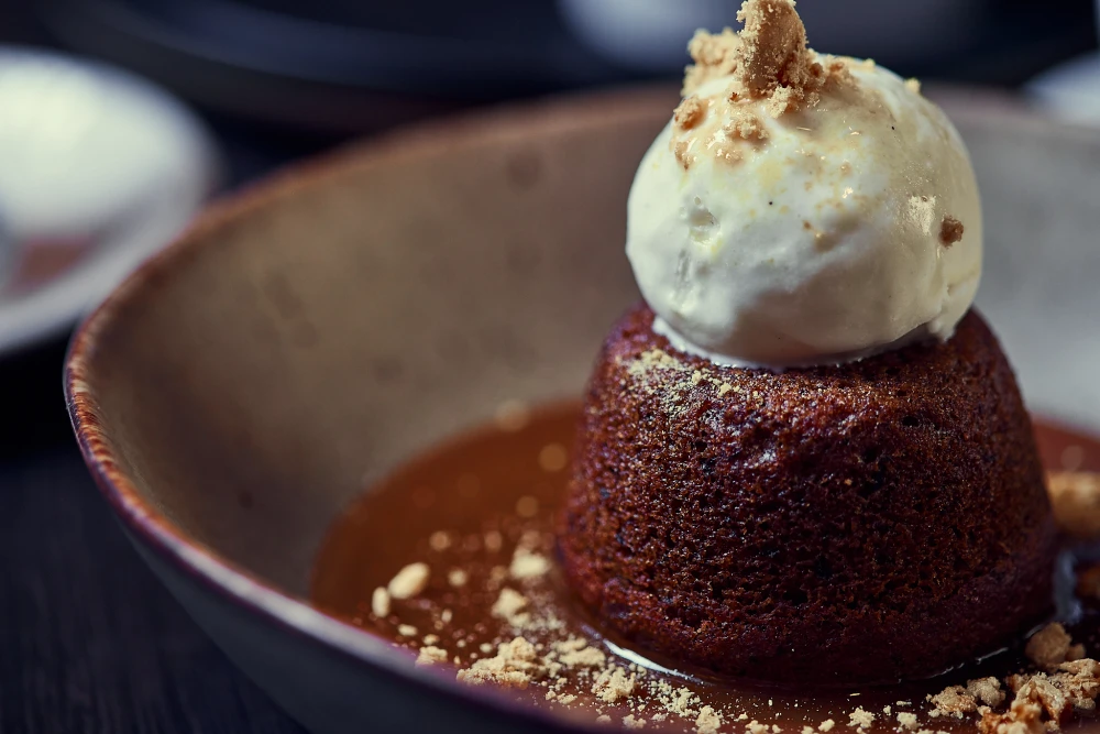 Sticky toffee pudding with caramel sauce and vanilla ice cream at The Maven