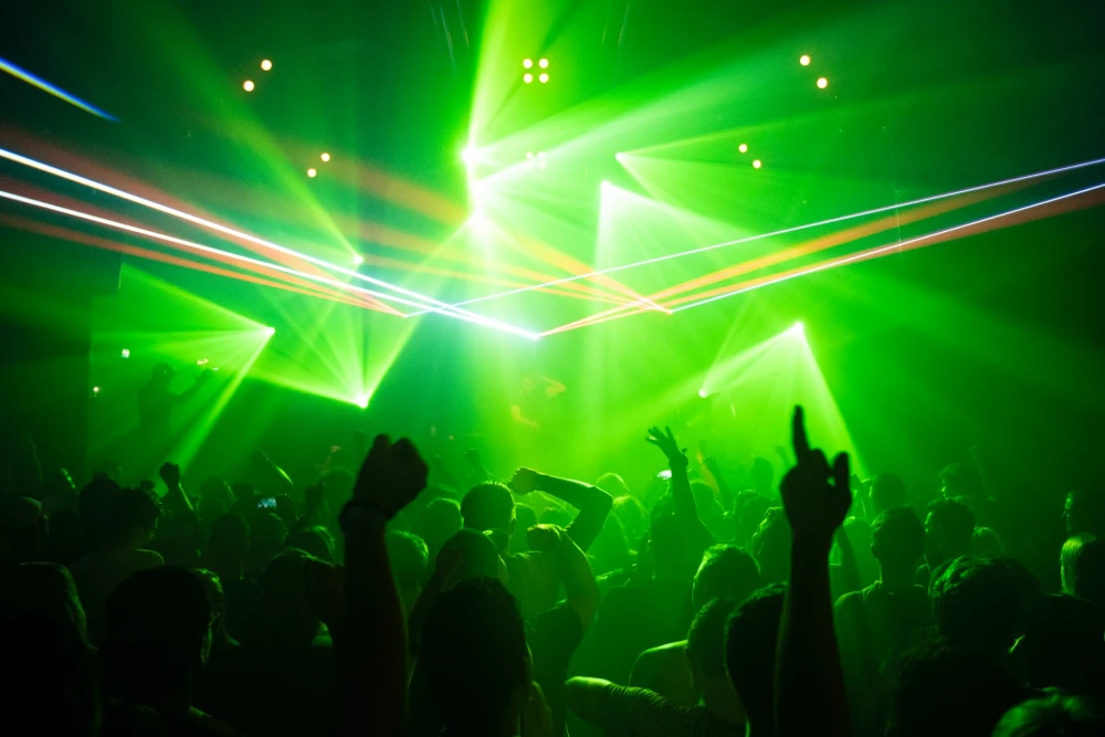 People dancing inside room with green lights, AJ, Unsplash